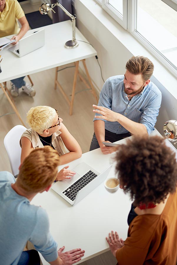 A diverse team laughing and brainstorming together