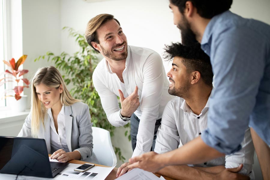 Three diverse professionals discussing ideas together